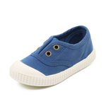 Blue children's shoe with white sole on a white background