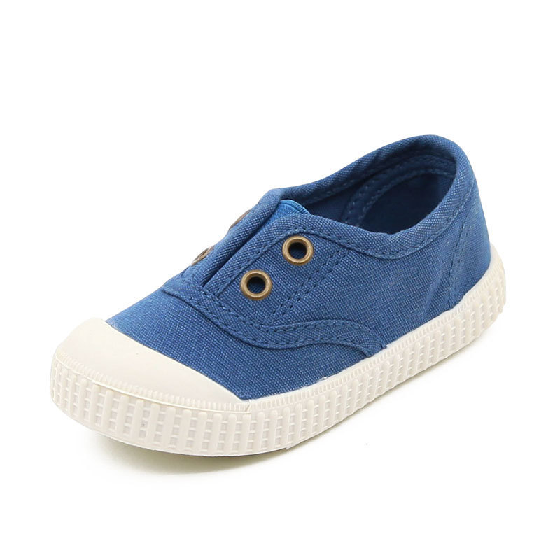 Blue children's shoe with white sole on a white background
