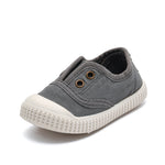 Gray casual shoe with white sole on a white background