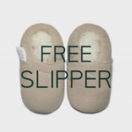 Beige slippers with 'FREE SLIPPER' text on a light gray background