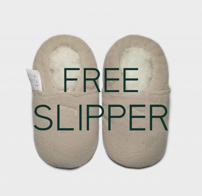 Beige slippers with 'FREE SLIPPER' text on a light gray background