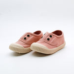 Pair of pink children's shoes on a white background