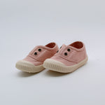 Pair of pink children's shoes on a light gray background