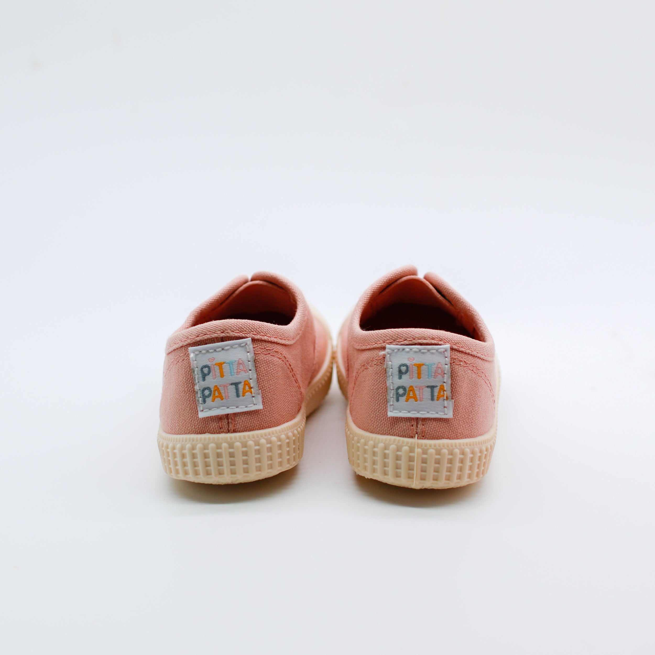 Pair of pink sneakers with 'Pita Pata' labels on a white background