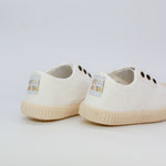 White sneakers with brand labels on a light gray background