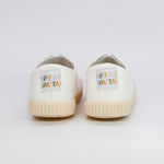 Pair of cream-colored sneakers with 'Pita Pata' branding on a light gray background