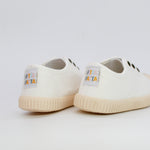 White sneakers with a brand label on a light gray background