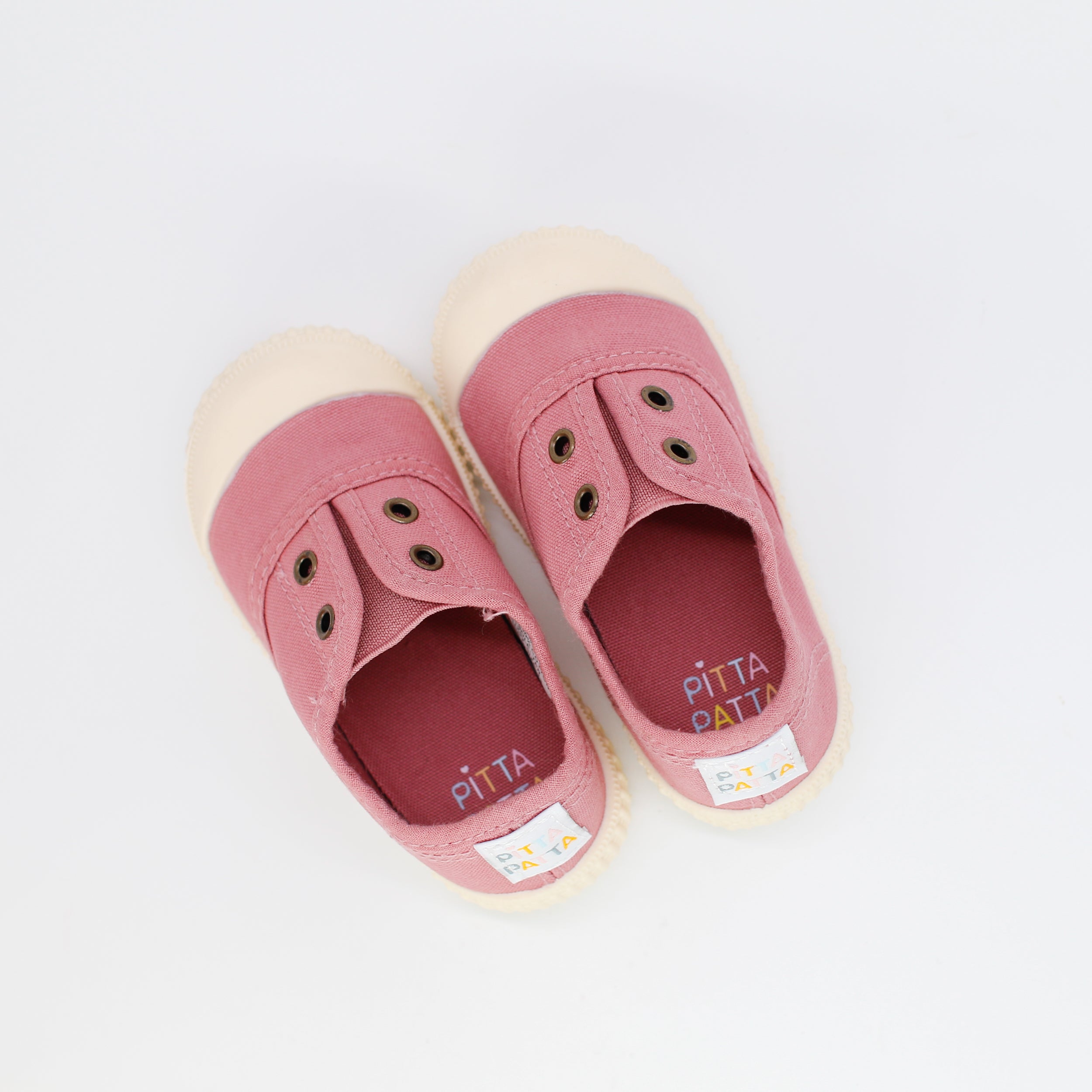 Pair of pink children's shoes with 'Pitta' branding on a white background