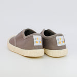 Pair of brown children's sneakers with visible brand label on a light gray background