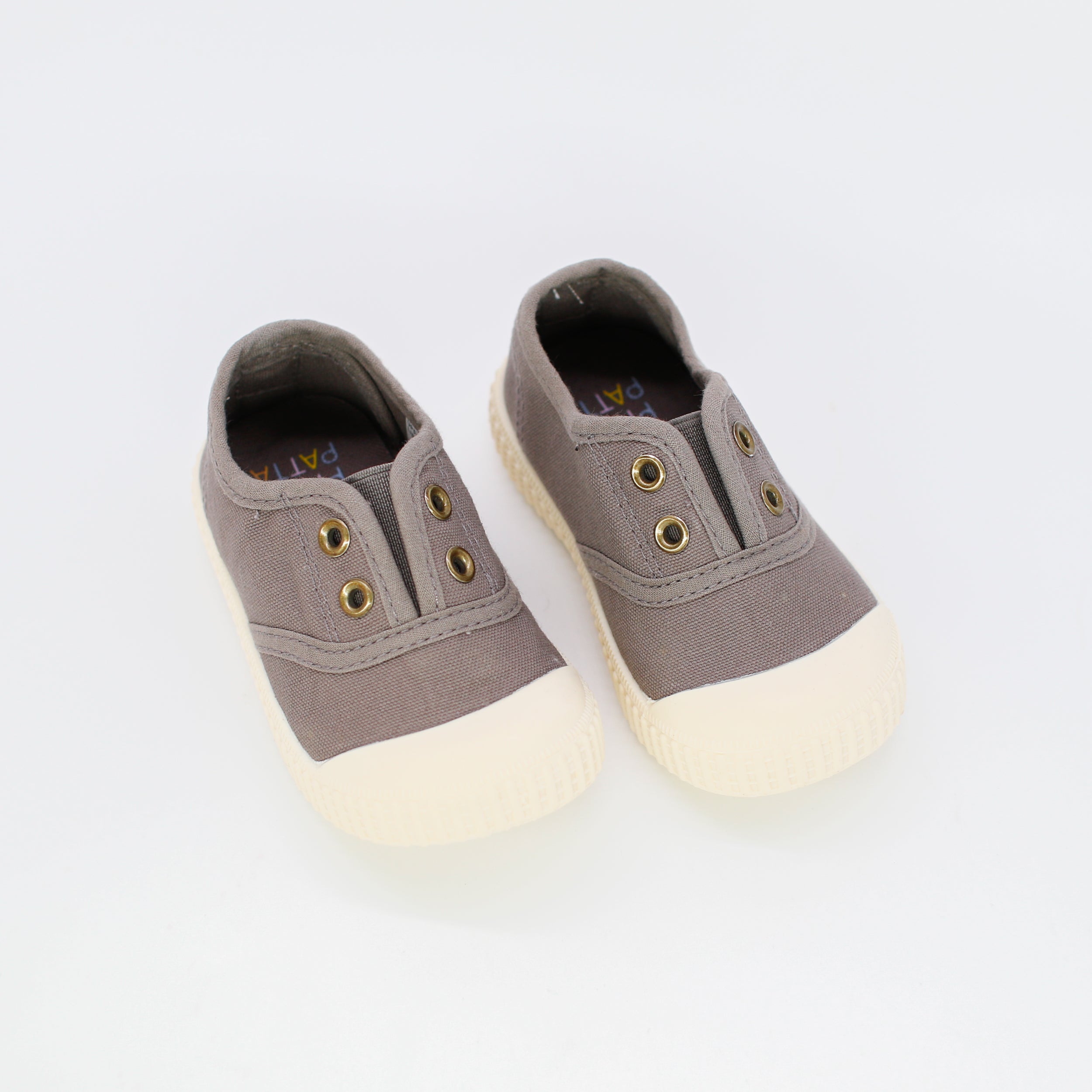Pair of gray sneakers with white soles on a light gray background