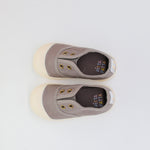 Pair of gray slip-on shoes with 'Pitta' branding on a light gray background