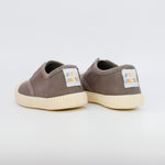 Pair of brown sneakers with white soles on a light gray background