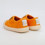 Orange children's shoes with 'Pipa' labels on a light gray background