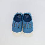 Pair of blue children's shoes with white soles on a light gray background