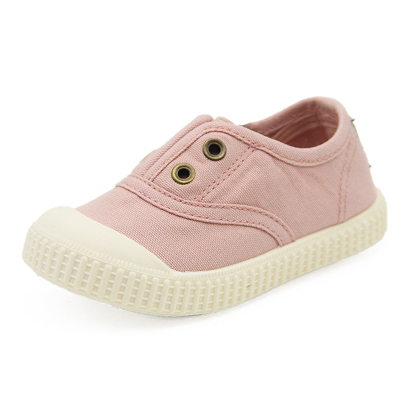 Pink children's shoe with a white sole on a white background